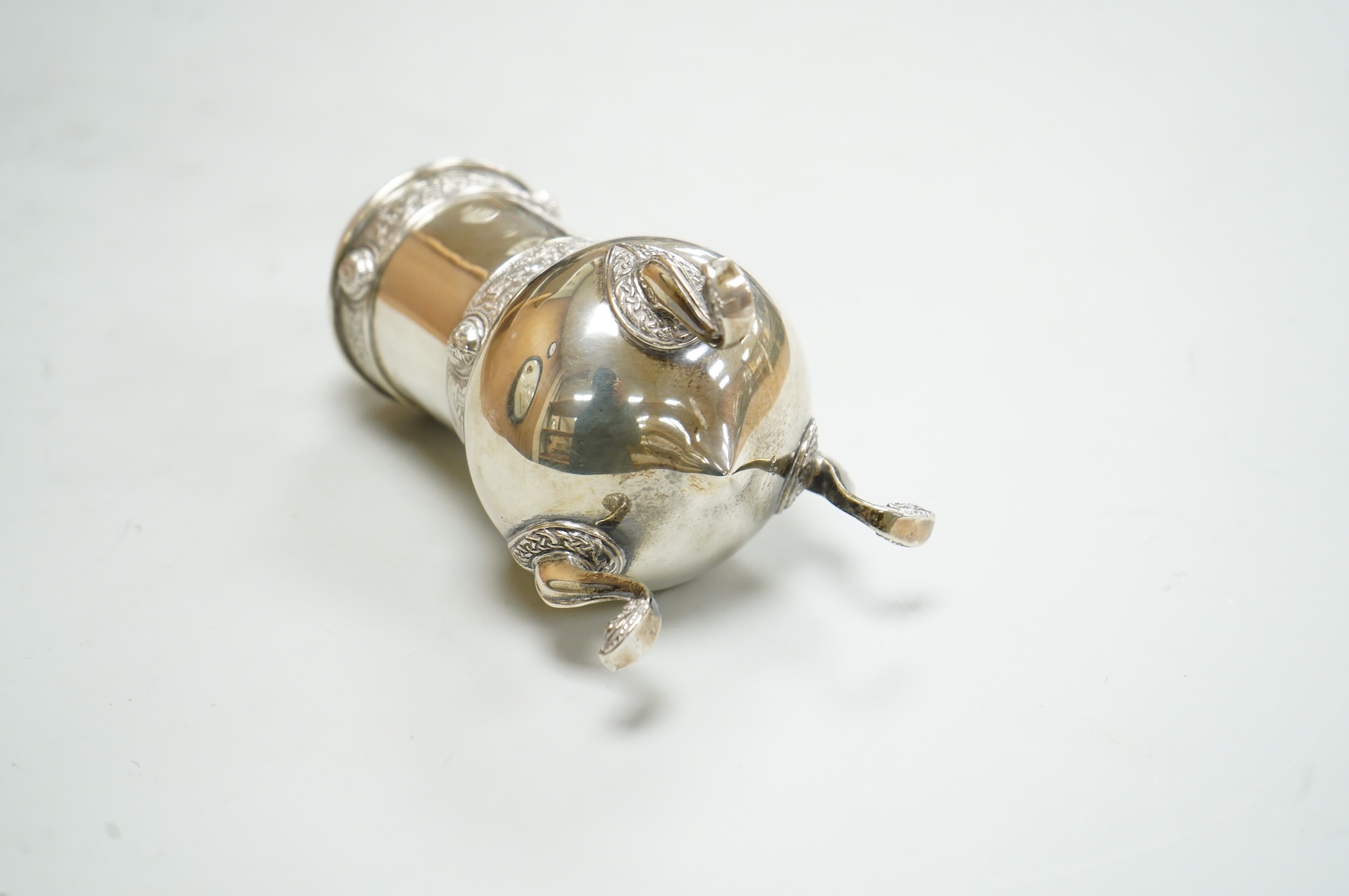 A George V Irish silver sugar caster, by West & Son, Dublin, 1914, decorated with Celtic bands, height 16.7cm, 9.9oz.